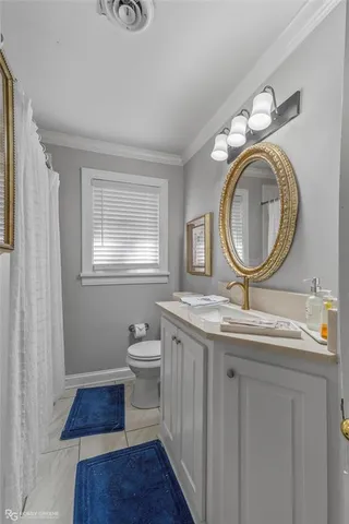 a bathroom with a toilet a sink and a mirror