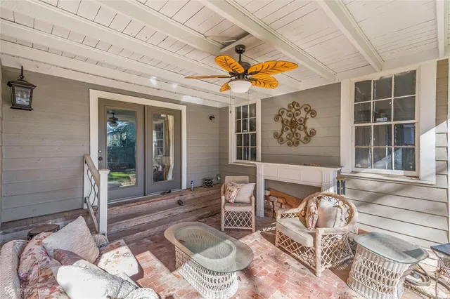 a living room with patio furniture and a window