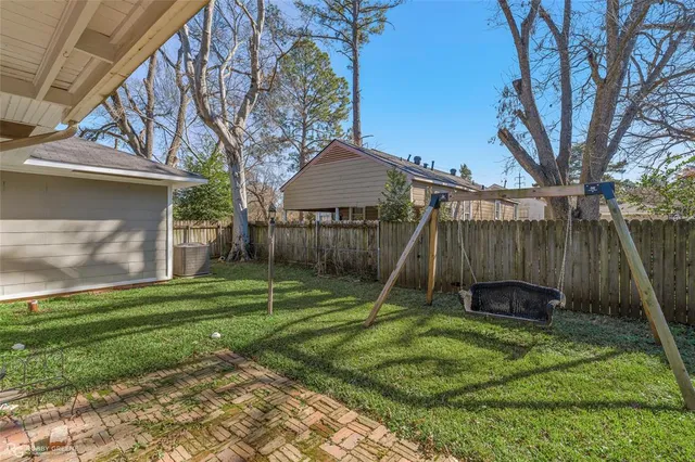 a backyard of a house with a yard and outdoor seating