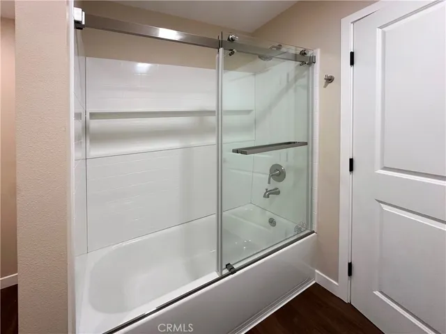 a bathroom with a glass shower door