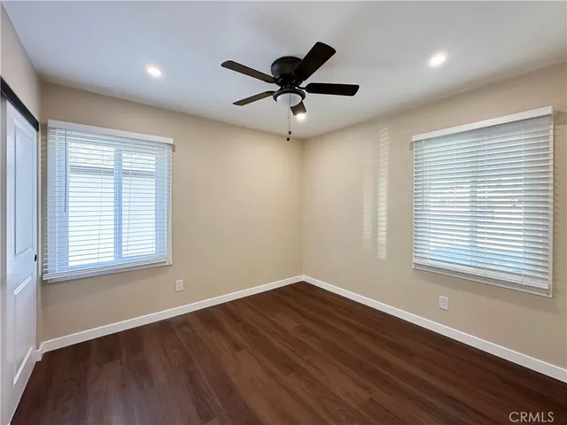 a view of a room with wooden floor and windows