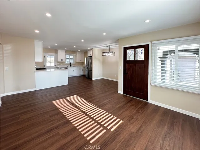 a view of kitchen with cabinets and wooden floor