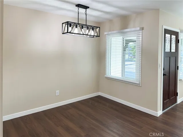 a view of a room with wooden floor and windows