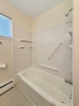 a bathroom with a bathtub and a shower
