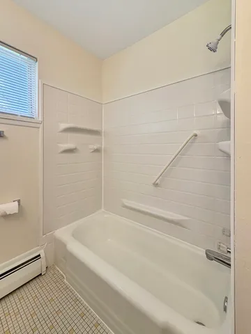 a bathroom with a bathtub and a shower