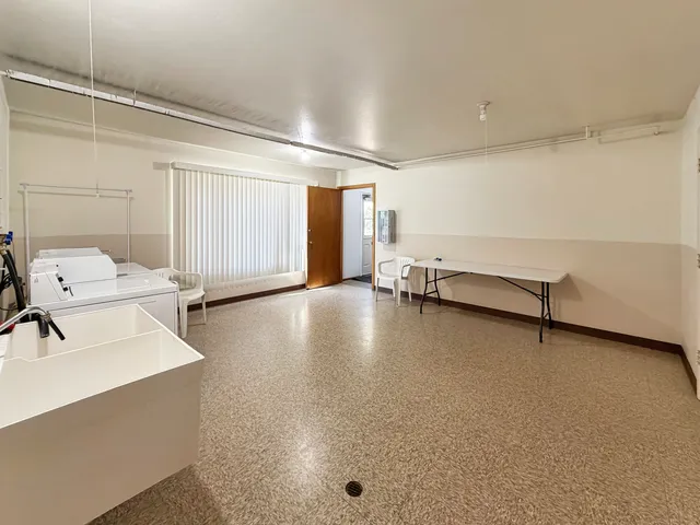 a view of a livingroom with bathroom and furniture