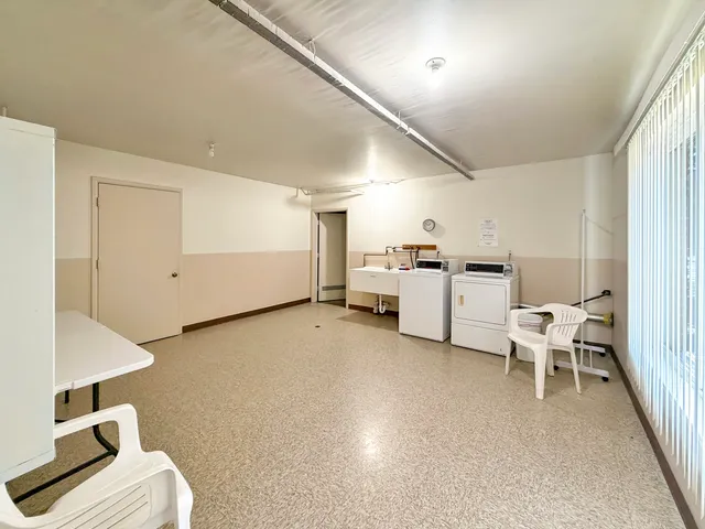 a view of a bedroom with furniture and refrigerator