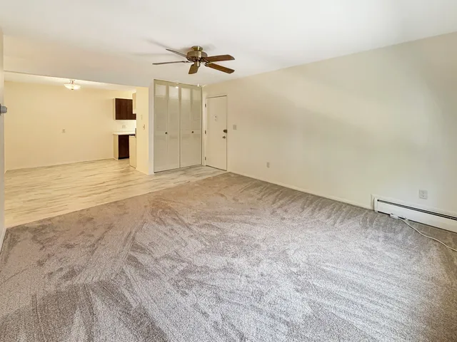 an empty room with a empty space and windows