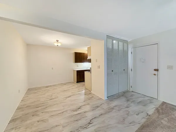 a view of empty room with a fireplace and cabinet