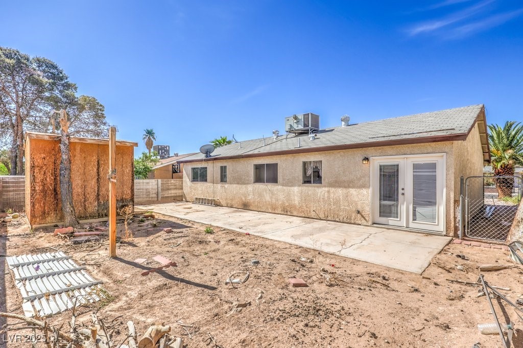 3948 Maple Hill Road Las Vegas, NV 89115 - Photo 20 of 20 Rear view of house featuring stucco siding, french doors, a patio area, a fenced backyard, and central AC