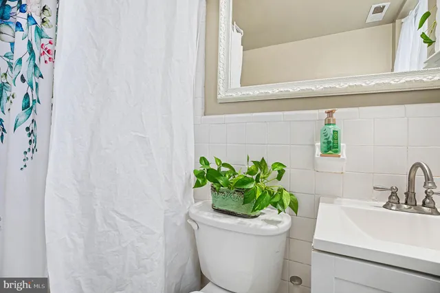 a bed room with a bed window and a dresser