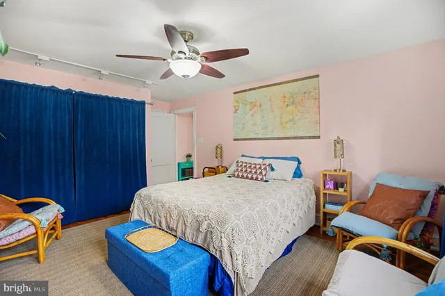 a bedroom with a bed and a painting on the wall