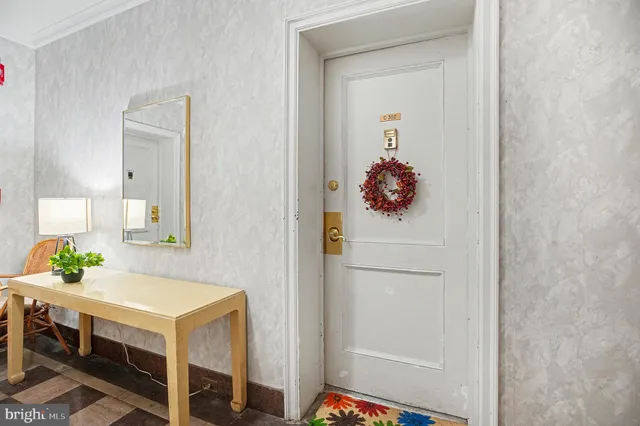a hallway with table and white furniture