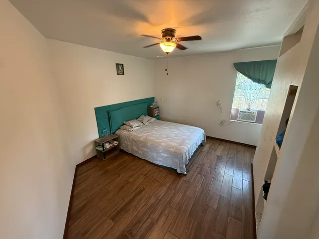 a bedroom with a bed and window