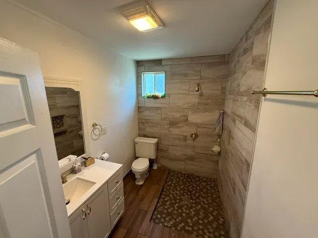 a bathroom with a sink toilet and shower