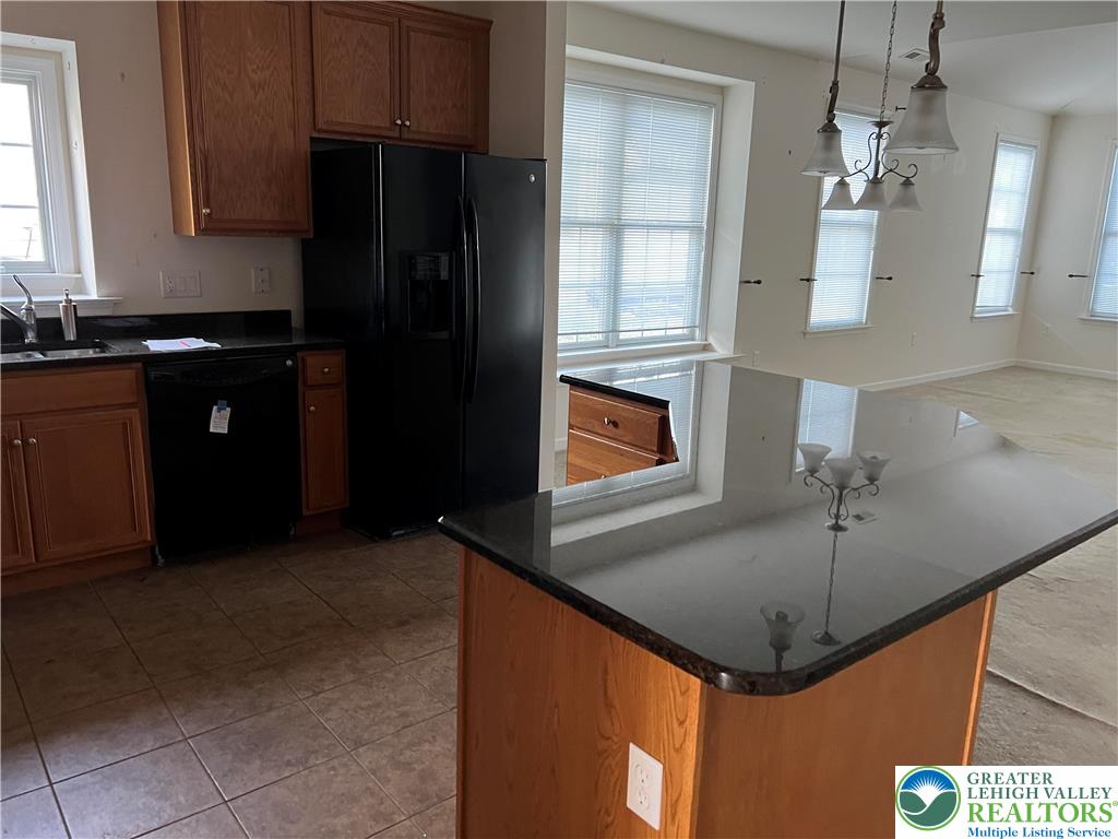6960 Constitution Drive Bethlehem, PA 18017 - Photo 11 of 18 a kitchen with stainless steel appliances granite countertop a refrigerator a sink and dishwasher