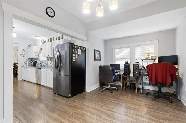 a view of kitchen with refrigerator and workspace