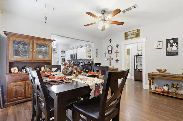 a view of a dining room with furniture and wooden floor