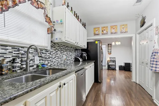 a kitchen with a sink and a refrigerator