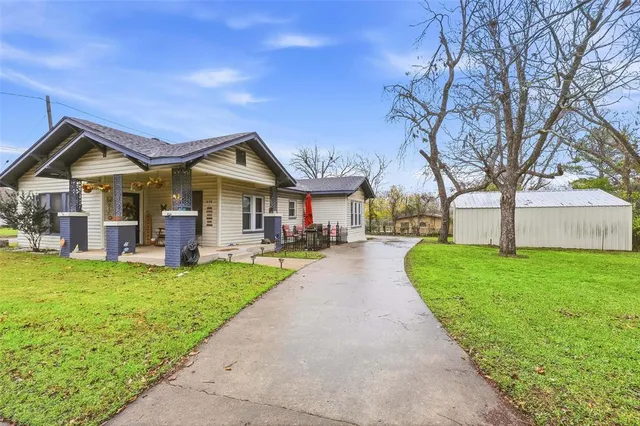 a front view of house with yard and green space