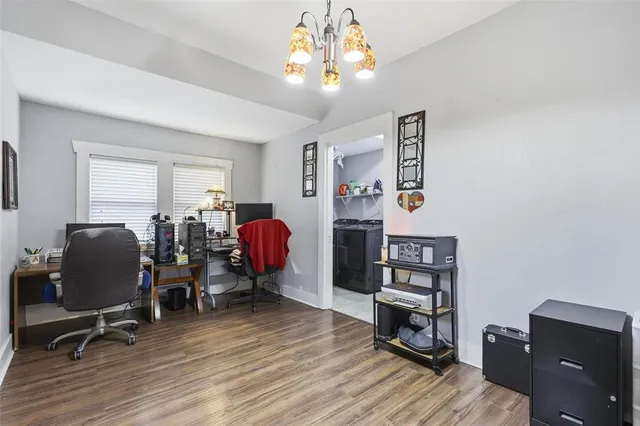 a view of a workspace with furniture and a window