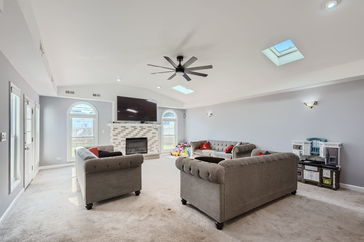 836 Spring Road Elmhurst, IL 60126 - Photo 14 of 31 a living room with furniture a fireplace and a flat screen tv