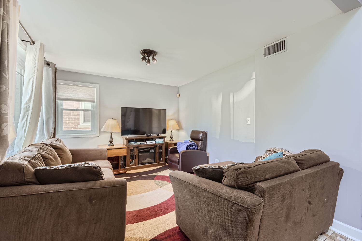 836 Spring Road Elmhurst, IL 60126 - Photo 5 of 31 a living room with furniture and a flat screen tv