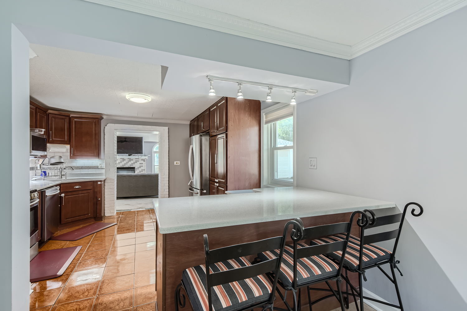 836 Spring Road Elmhurst, IL 60126 - Photo 8 of 31 a kitchen with stainless steel appliances granite countertop a stove top oven a sink a dining table and chairs
