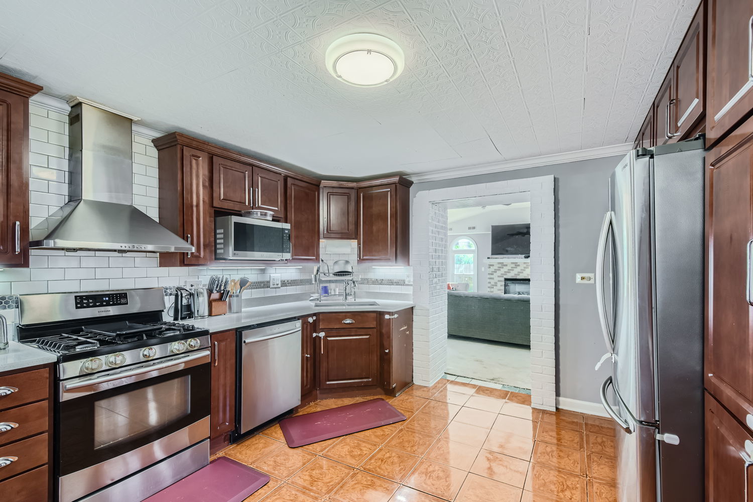 836 Spring Road Elmhurst, IL 60126 - Photo 9 of 31 a kitchen with stainless steel appliances granite countertop a stove top oven a sink and a refrigerator