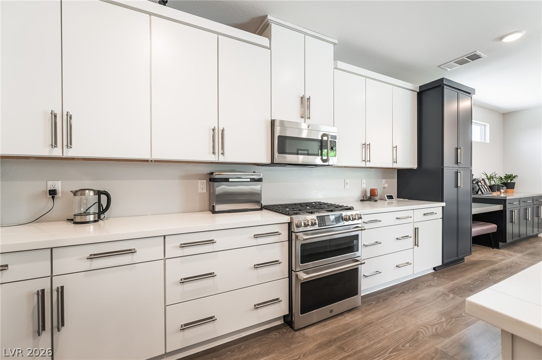 2166 Trivero Street Henderson, NV 89044 - Photo 12 of 61 A sleek culinary space awaits, featuring extensive cabinetry and a full suite of modern appliances.
