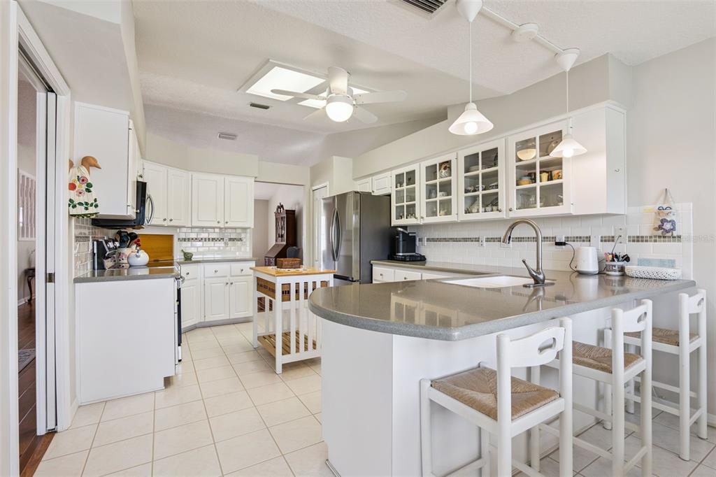 26450 Evert Street Leesburg, FL 34748 - Photo 12 of 93 a kitchen with cabinets and chairs