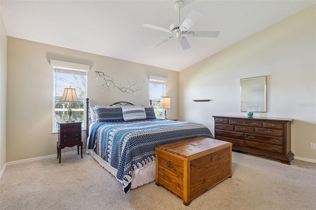 26450 Evert Street Leesburg, FL 34748 - Photo 26 of 93 a spacious bedroom with a bed and a dresser