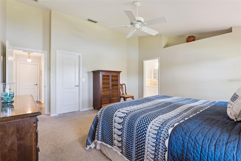26450 Evert Street Leesburg, FL 34748 - Photo 27 of 93 a bedroom with a large bed and chandelier
