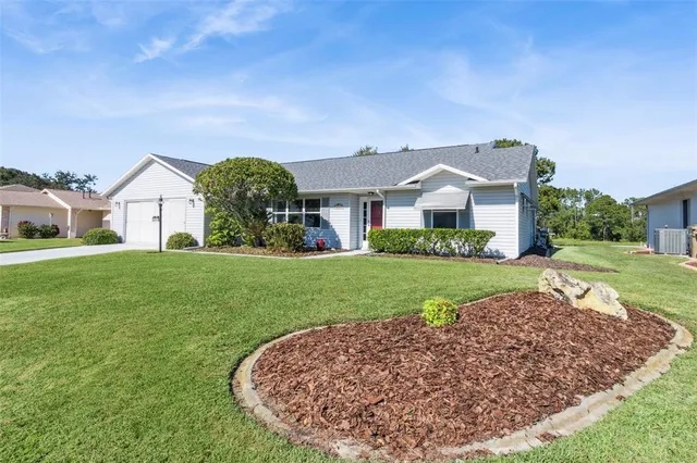 a view of a house with pool and a yard
