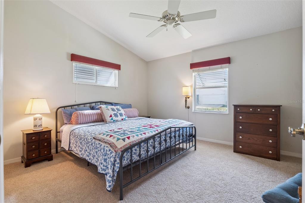 26450 Evert Street Leesburg, FL 34748 - Photo 31 of 93 a bedroom with a bed a chandelier and a window