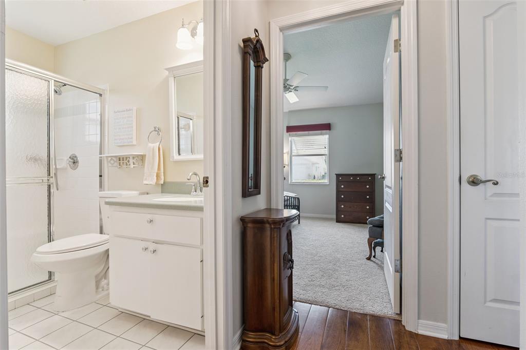 26450 Evert Street Leesburg, FL 34748 - Photo 33 of 93 a bathroom with a granite countertop sink toilet and shower