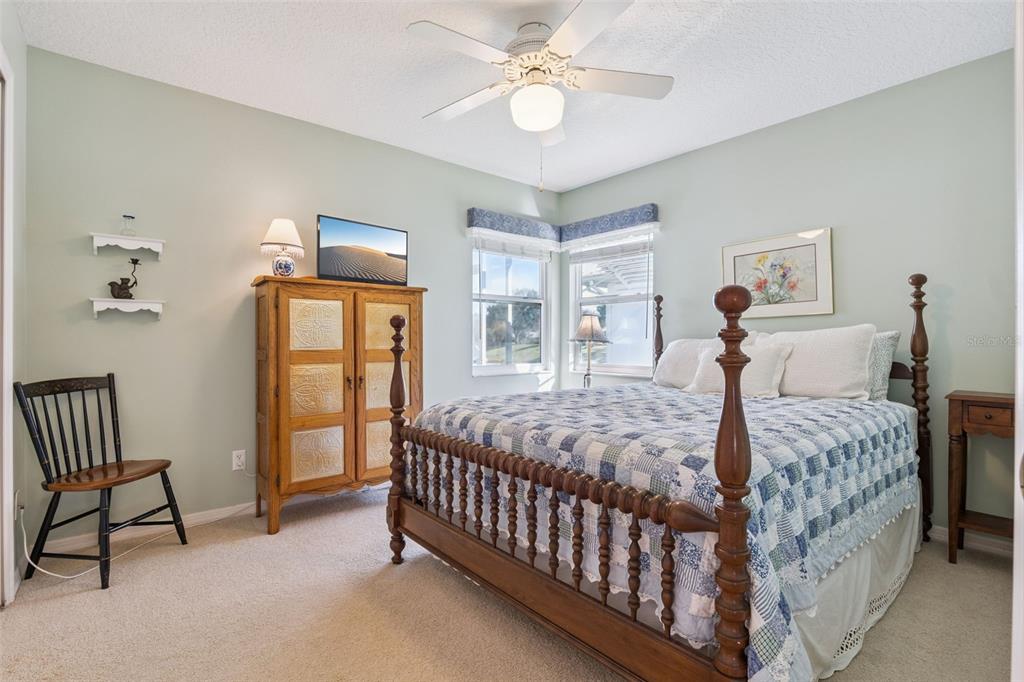 26450 Evert Street Leesburg, FL 34748 - Photo 34 of 93 a bedroom with a bed and a chandelier