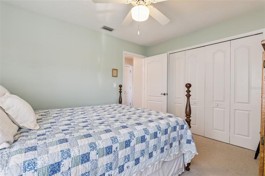 26450 Evert Street Leesburg, FL 34748 - Photo 35 of 93 a bedroom with a bed and a chandelier