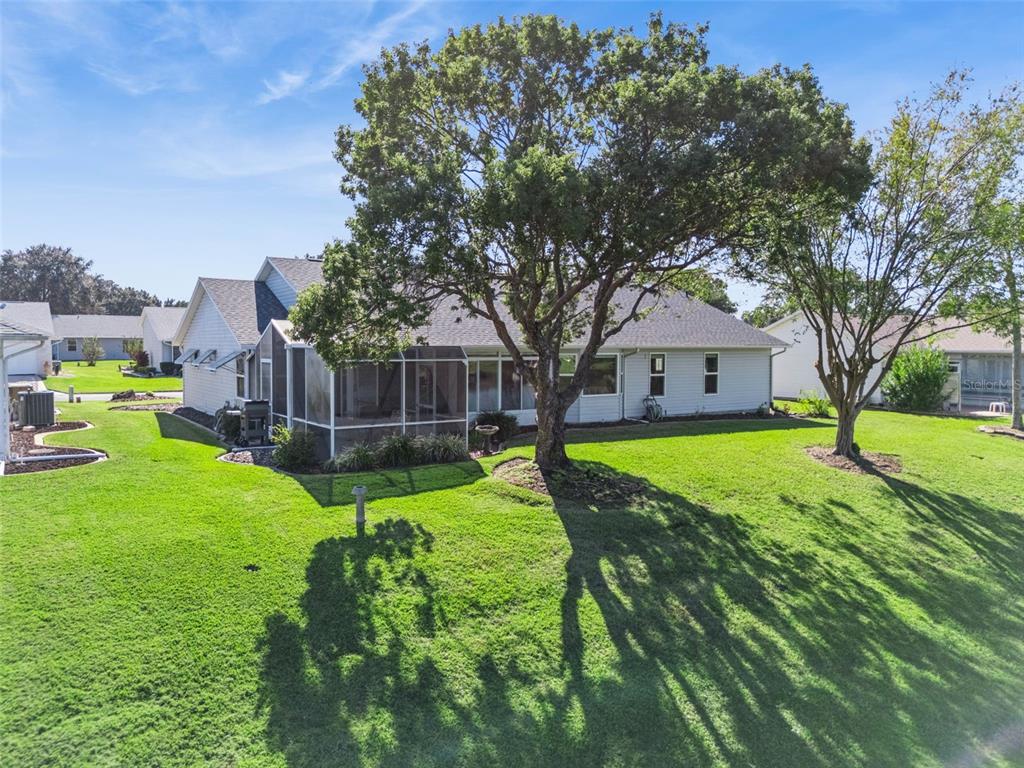 26450 Evert Street Leesburg, FL 34748 - Photo 45 of 93 a view of a house with backyard and sitting area
