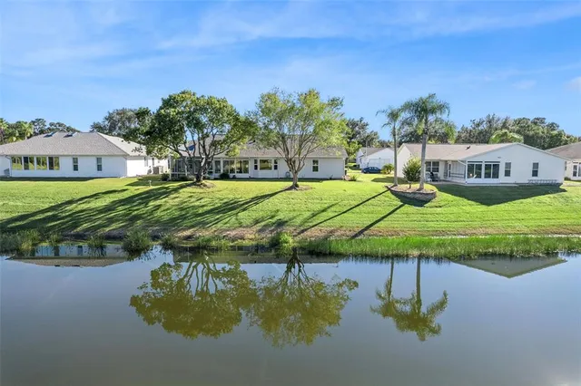 an aerial view of a house with outdoor space and lake view