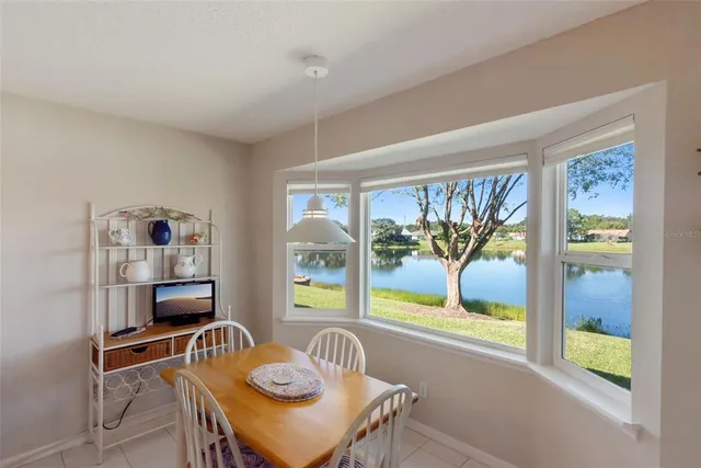 a kitchen with stainless steel appliances granite countertop a stove refrigerator a sink dishwasher with a dining table and chairs