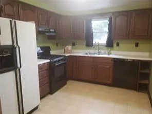 a kitchen with stainless steel appliances a sink stove and refrigerator