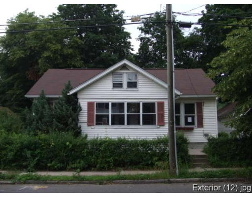 51 Milton Street Springfield, MA 01151 - Photo 1 of 1 a view of a house with a yard and large tree