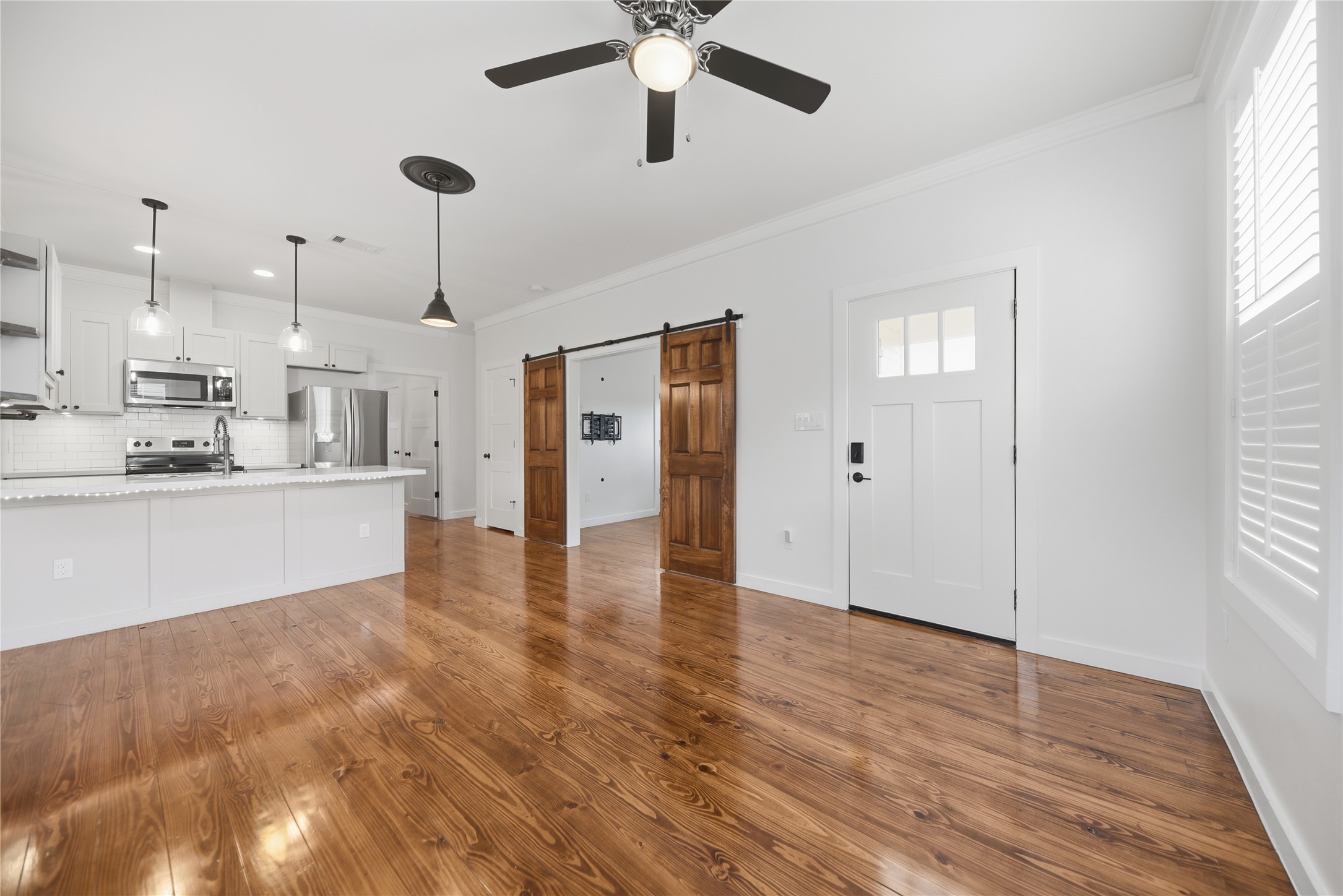 704 Burleson Street Brenham, TX 77833 - Photo 1 of 28 a view of a kitchen with a sink dishwasher refrigerator stove and a window