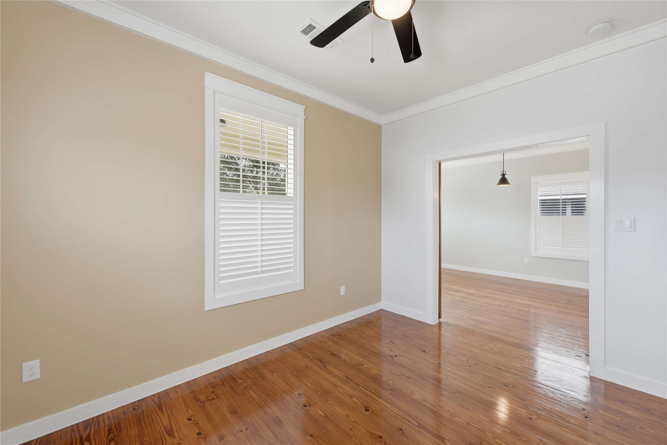 704 Burleson Street Brenham, TX 77833 - Photo 11 of 28 a view of an empty room with wooden floor and a window