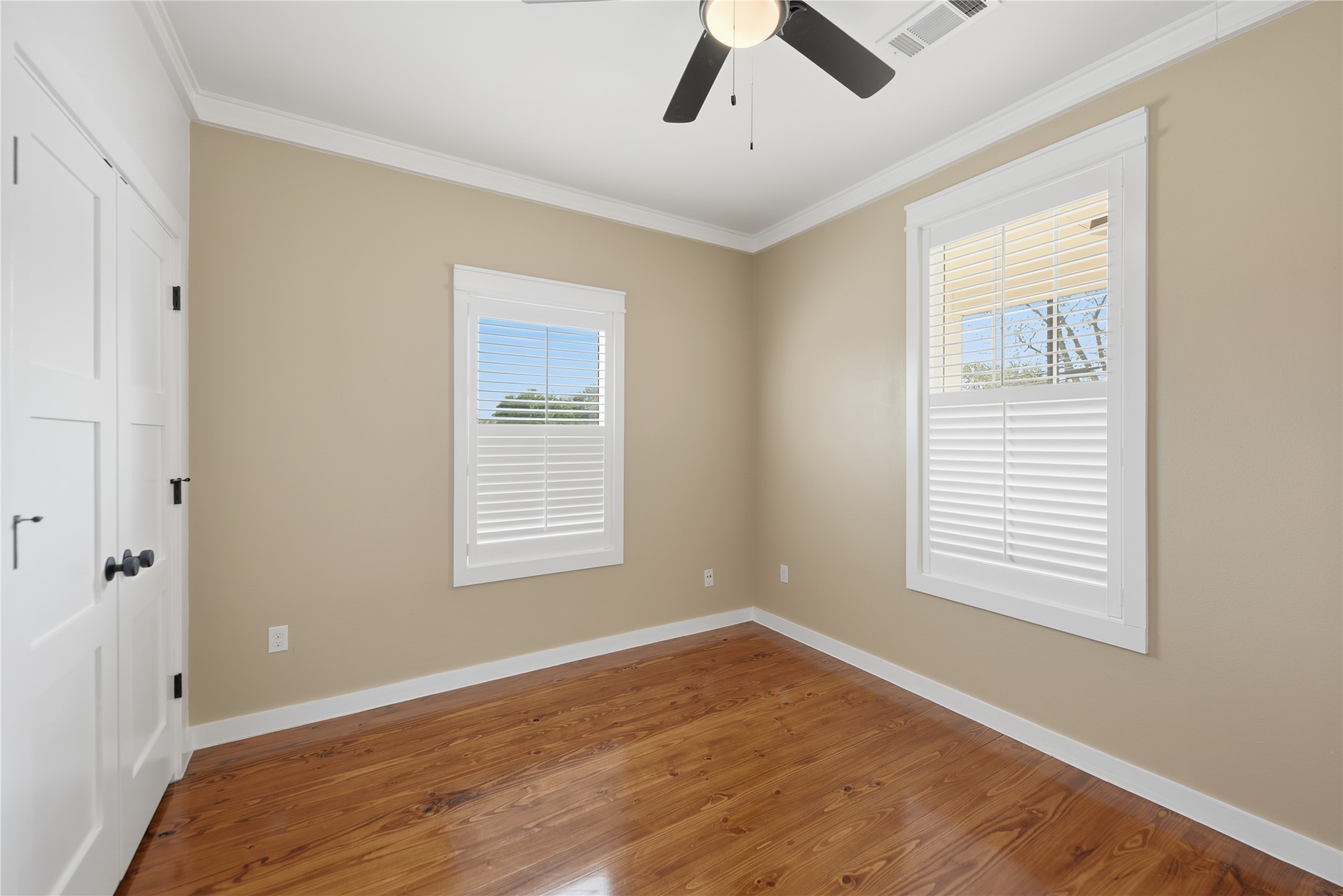 704 Burleson Street Brenham, TX 77833 - Photo 12 of 28 a view of an empty room with wooden floor and a window