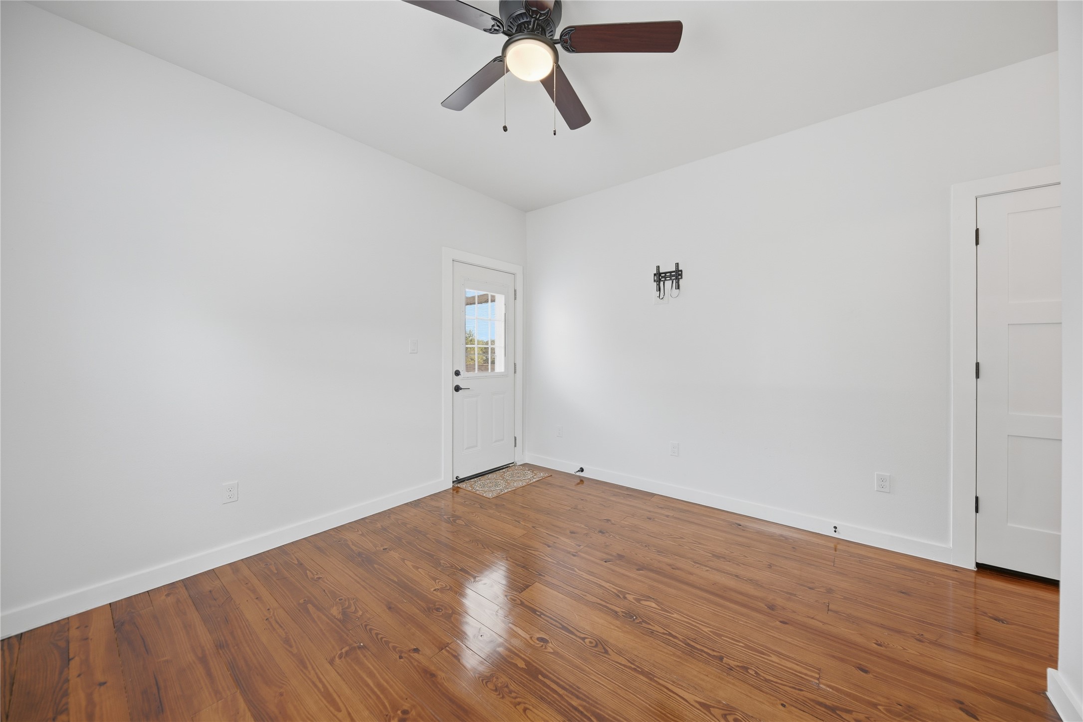 704 Burleson Street Brenham, TX 77833 - Photo 14 of 28 wooden floor in an empty room