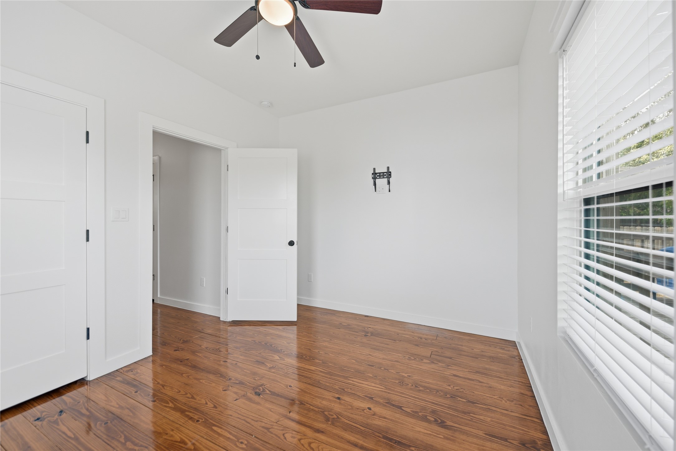 704 Burleson Street Brenham, TX 77833 - Photo 16 of 28 wooden floor in an empty room