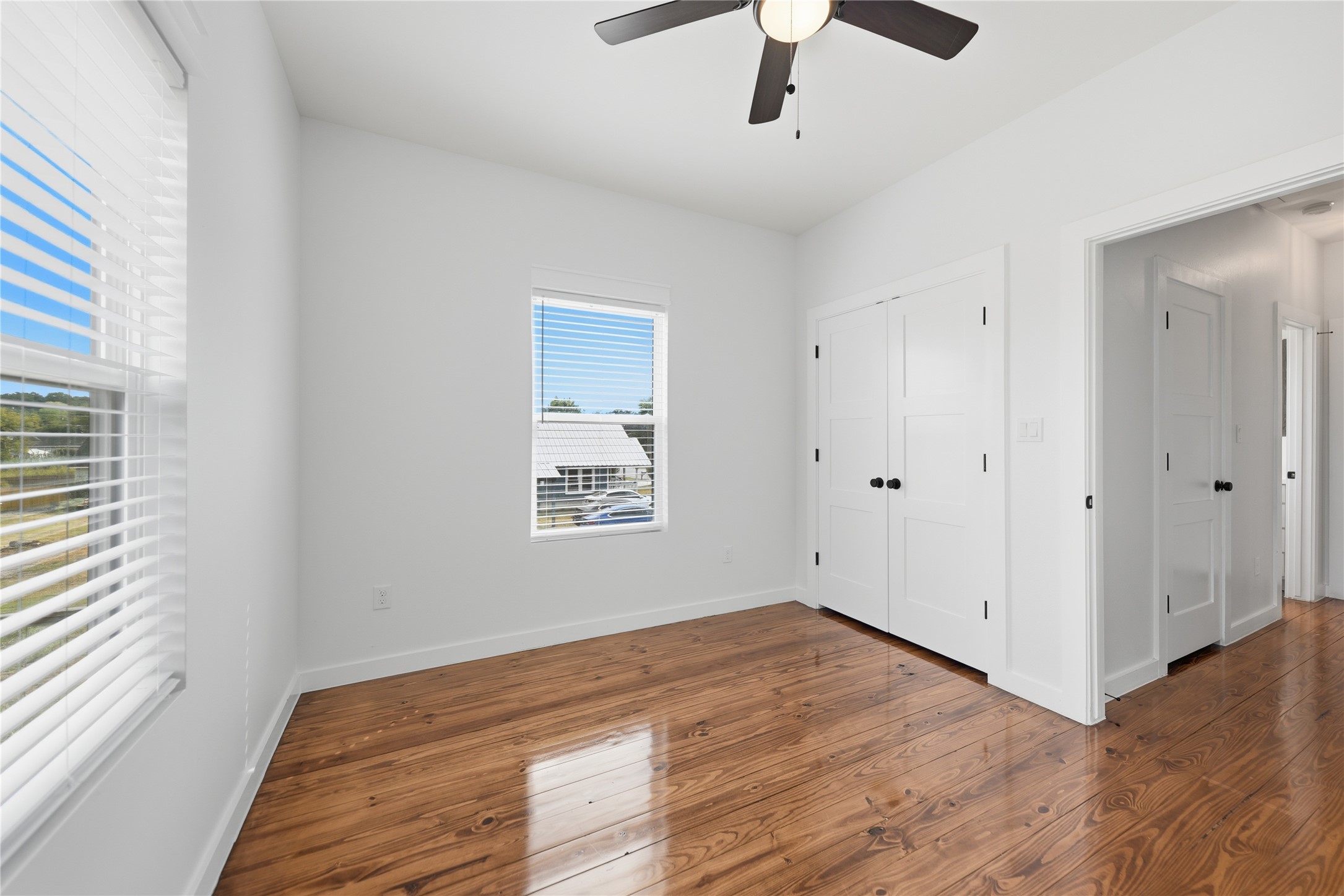 704 Burleson Street Brenham, TX 77833 - Photo 18 of 28 wooden floor in an empty room with a window