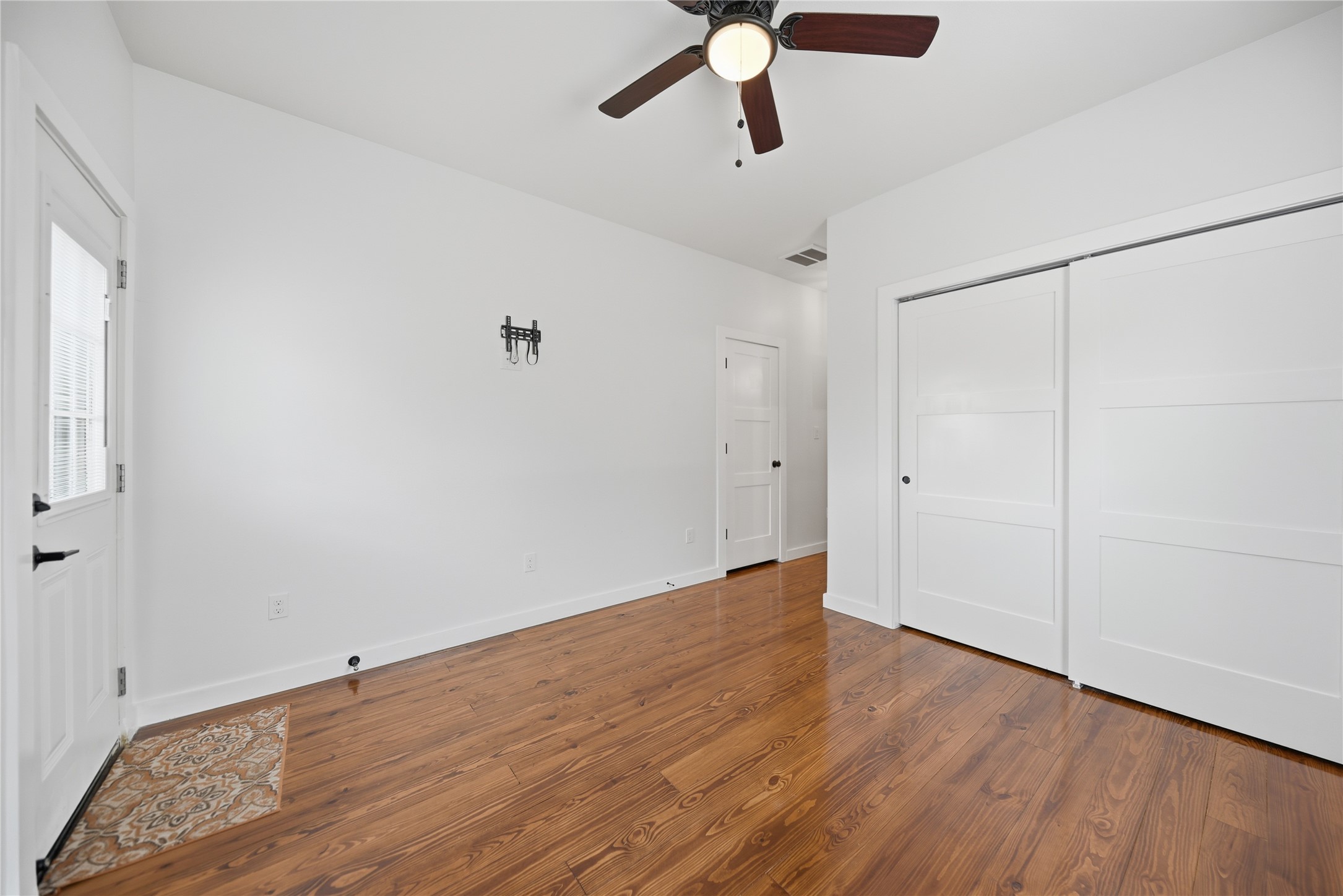 704 Burleson Street Brenham, TX 77833 - Photo 20 of 28 wooden floor in an empty room